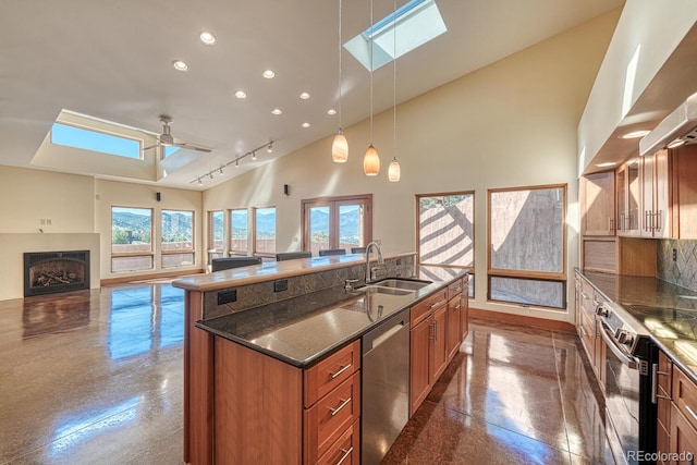 10405 W Cherokee Dr, Salida, CO 81201 - kitchen with appliances with stainless steel finishes, a skylight, brown cabinets, an island with sink, and recessed lighting