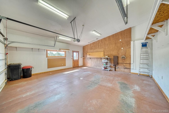 10405 W Cherokee Dr, Salida, CO 81201 - garage featuring a garage door opener and wood walls