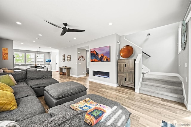 15547 W Vassar Ave, Lakewood, CO 80228 - living area featuring a ceiling fan, stairs, wood finished floors, recessed lighting, and a glass covered fireplace