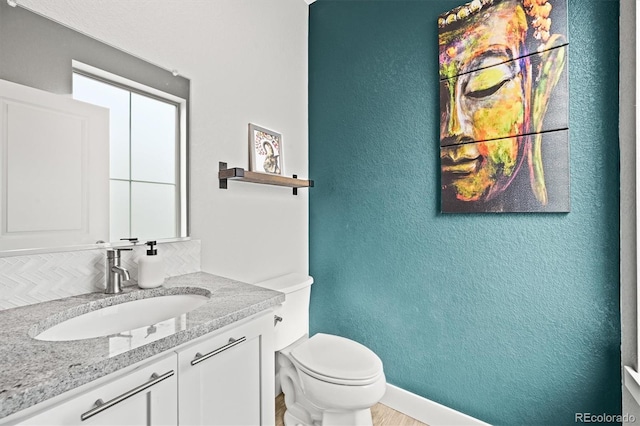15547 W Vassar Ave, Lakewood, CO 80228 - bathroom featuring vanity, a textured wall, and tasteful backsplash