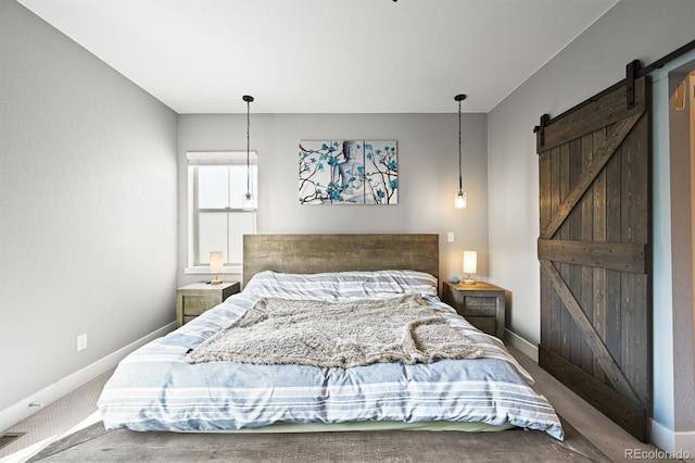 15547 W Vassar Ave, Lakewood, CO 80228 - carpeted bedroom featuring a barn door and baseboards