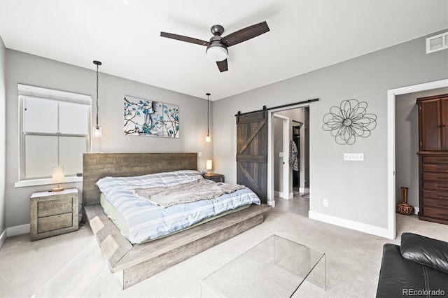 15547 W Vassar Ave, Lakewood, CO 80228 - carpeted bedroom featuring a barn door and ceiling fan