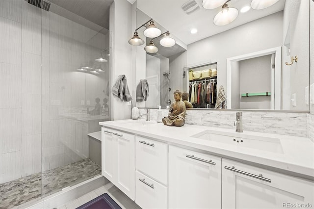 15547 W Vassar Ave, Lakewood, CO 80228 - full bath featuring double vanity, tiled shower, and a spacious closet