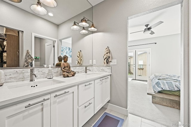 15547 W Vassar Ave, Lakewood, CO 80228 - full bath with double vanity, healthy amount of natural light, and ceiling fan