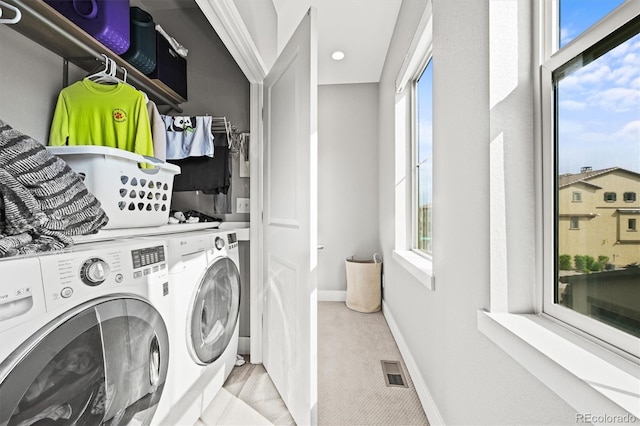 15547 W Vassar Ave, Lakewood, CO 80228 - laundry area with washing machine and clothes dryer, plenty of natural light, and recessed lighting