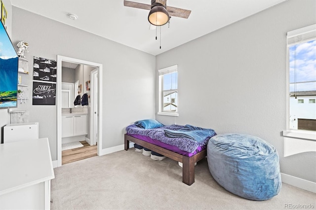 15547 W Vassar Ave, Lakewood, CO 80228 - carpeted bedroom featuring ensuite bathroom and a ceiling fan