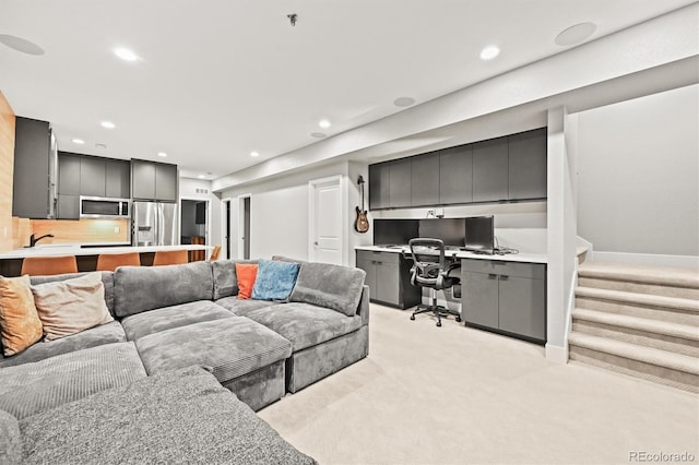 15547 W Vassar Ave, Lakewood, CO 80228 - living room featuring light carpet, recessed lighting, built in desk, and stairs
