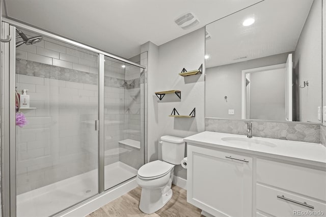 15547 W Vassar Ave, Lakewood, CO 80228 - bathroom featuring wood finished floors, vanity, and a stall shower