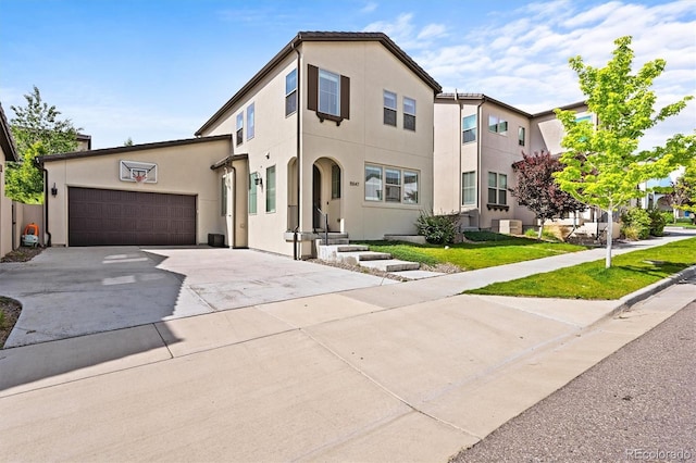 15547 W Vassar Ave, Lakewood, CO 80228 - view of front of property with concrete driveway, an attached garage, and stucco siding