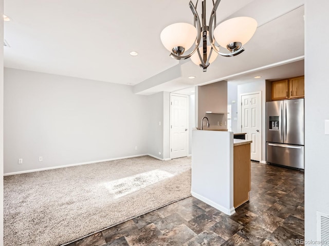 kitchen with kitchen peninsula, stainless steel fridge, and dark carpet