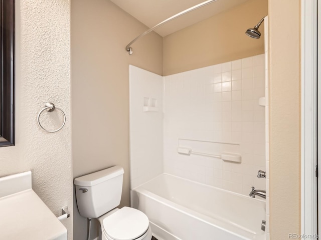 bathroom with tiled shower / bath combo and toilet