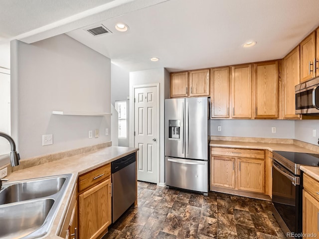 5888 Biscay St Unit D, Denver, CO 80249 - kitchen featuring appliances with stainless steel finishes, a sink, light countertops, recessed lighting, and stone finish flooring