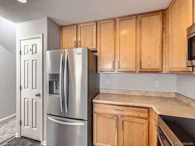 5888 Biscay St Unit D, Denver, CO 80249 - kitchen with stainless steel fridge with ice dispenser, light countertops, a textured ceiling, dark wood finished floors, and light brown cabinets