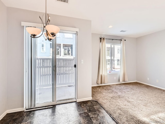 5888 Biscay St Unit D, Denver, CO 80249 - doorway to outside featuring a chandelier, healthy amount of natural light, and baseboards