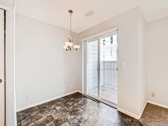 5888 Biscay St Unit D, Denver, CO 80249 - unfurnished dining area featuring a chandelier, baseboards, and dark stone finish floors