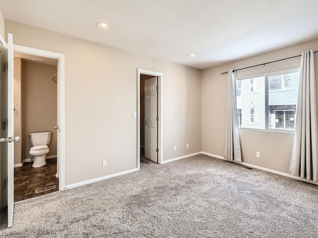 5888 Biscay St Unit D, Denver, CO 80249 - unfurnished bedroom with carpet flooring, baseboards, ensuite bathroom, and recessed lighting