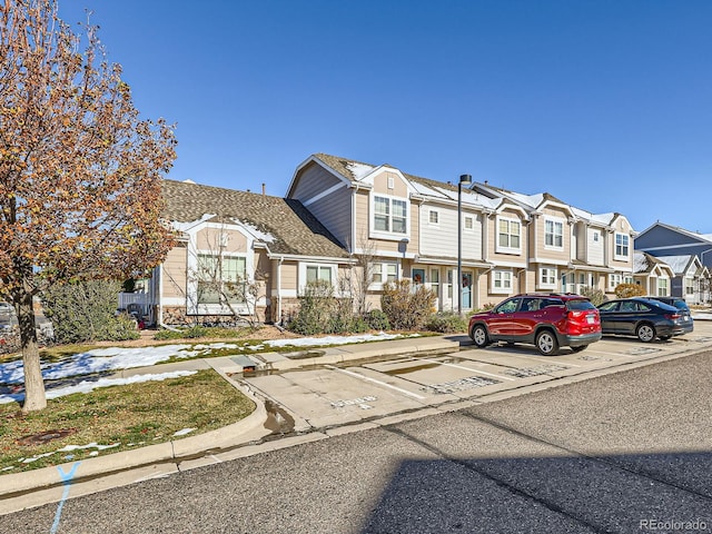 5888 Biscay St Unit D, Denver, CO 80249 - view of front of property with a residential view, uncovered parking, and stone siding