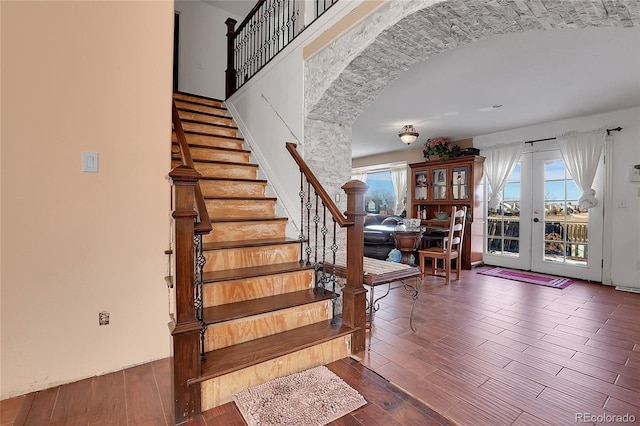 foyer featuring dark hardwood / wood-style flooring, french doors, and a healthy amount of sunlight