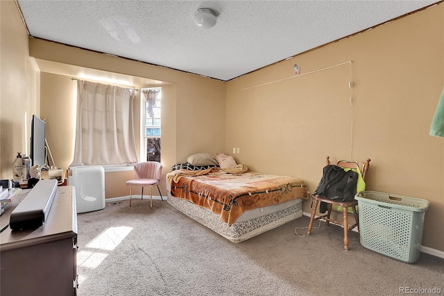 bedroom with carpet and a textured ceiling