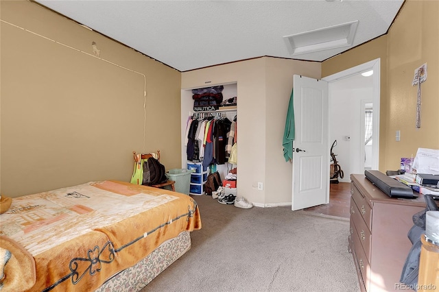 carpeted bedroom with a closet and a textured ceiling