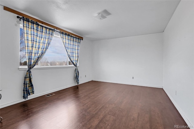 empty room featuring dark wood-type flooring