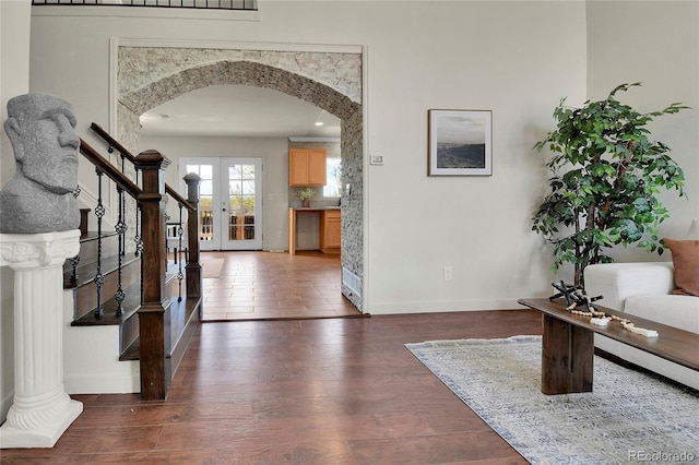 21455 E 44th Ave, Denver, CO 80249 - entryway featuring french doors, arched walkways, wood finished floors, baseboards, and stairs