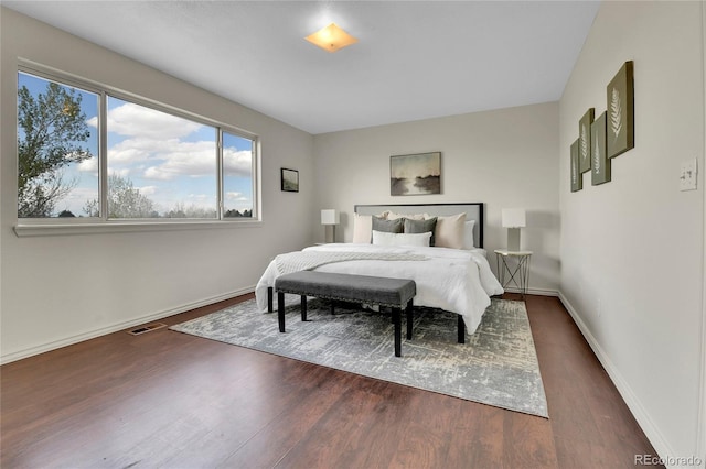 21455 E 44th Ave, Denver, CO 80249 - bedroom featuring baseboards, multiple windows, and dark wood-style floors