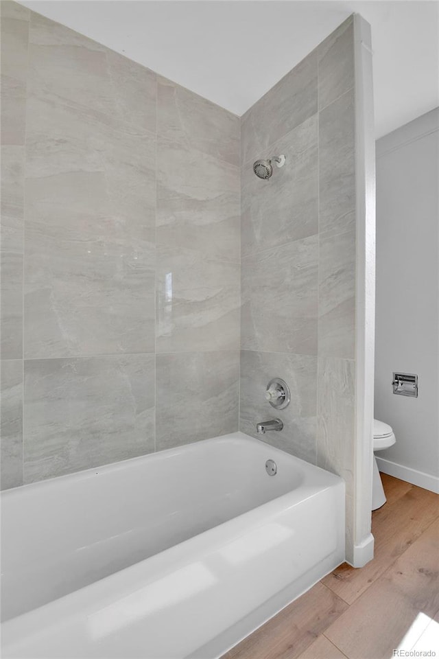21455 E 44th Ave, Denver, CO 80249 - full bath featuring  shower combination, wood finished floors, and toilet