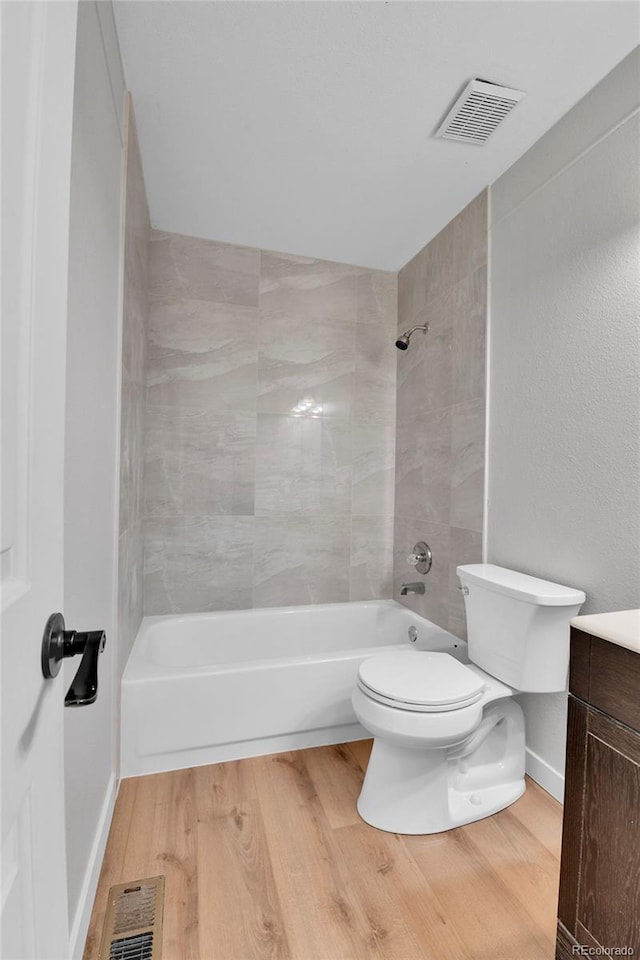 21455 E 44th Ave, Denver, CO 80249 - bathroom featuring vanity, toilet, shower / washtub combination, wood finished floors, and visible vents