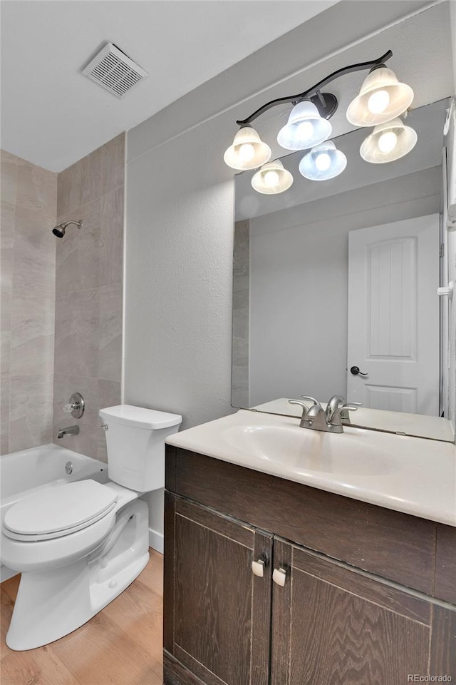 21455 E 44th Ave, Denver, CO 80249 - full bathroom featuring visible vents, vanity, wood finished floors, toilet, and shower / bath combination
