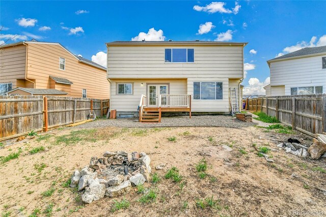 21455 E 44th Ave, Denver, CO 80249 - rear view of property featuring french doors, a fenced backyard, and a wooden deck