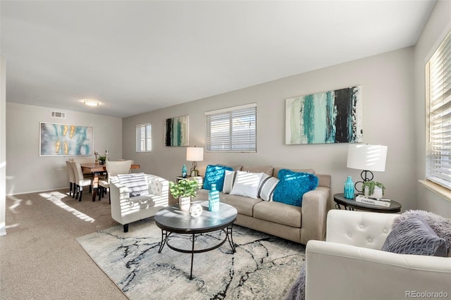 carpeted living room featuring a healthy amount of sunlight