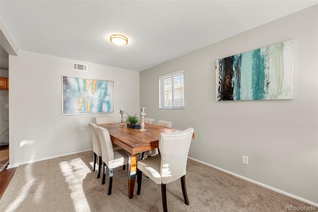 dining space featuring carpet flooring