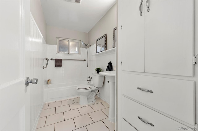 bathroom with tile patterned flooring, toilet, and tiled shower / bath