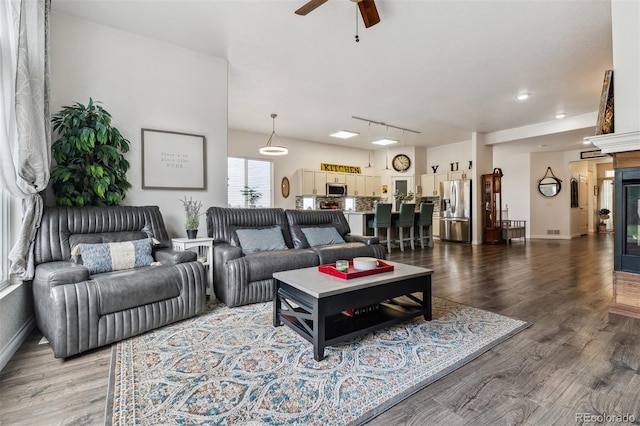 4293 Clover Ln, Brighton, CO 80601 - living area featuring a ceiling fan, wood finished floors, baseboards, and track lighting