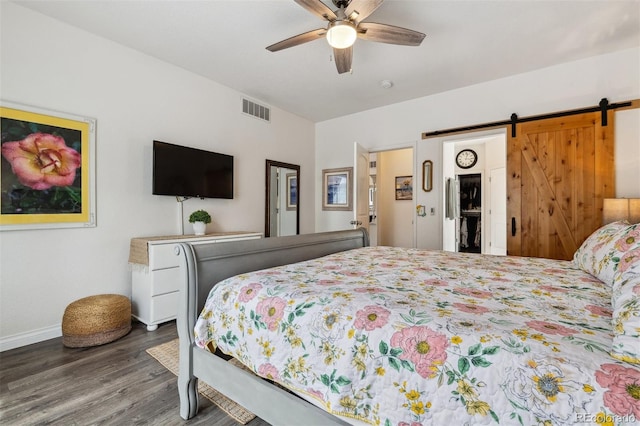4293 Clover Ln, Brighton, CO 80601 - bedroom with wood finished floors, baseboards, a barn door, and ceiling fan