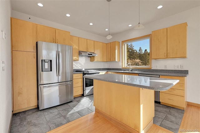 kitchen featuring light tile patterned floors, stainless steel appliances, light brown cabinets, hanging light fixtures, and a center island