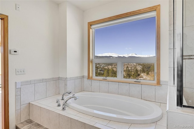 bathroom with a relaxing tiled tub