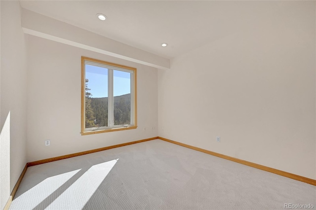 empty room with light carpet and a mountain view