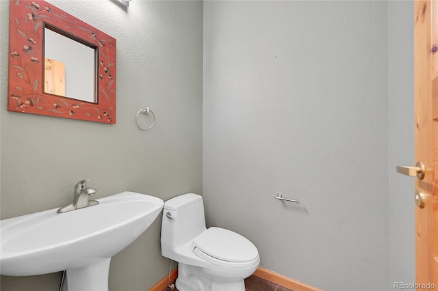 54 Doe Trl, Nederland, CO 80466 - half bathroom featuring a sink, toilet, and baseboards