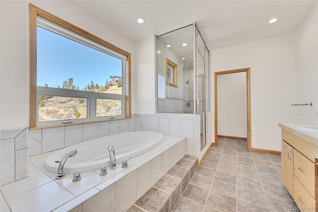 54 Doe Trl, Nederland, CO 80466 - bathroom featuring a stall shower, a garden tub, recessed lighting, baseboards, and vanity
