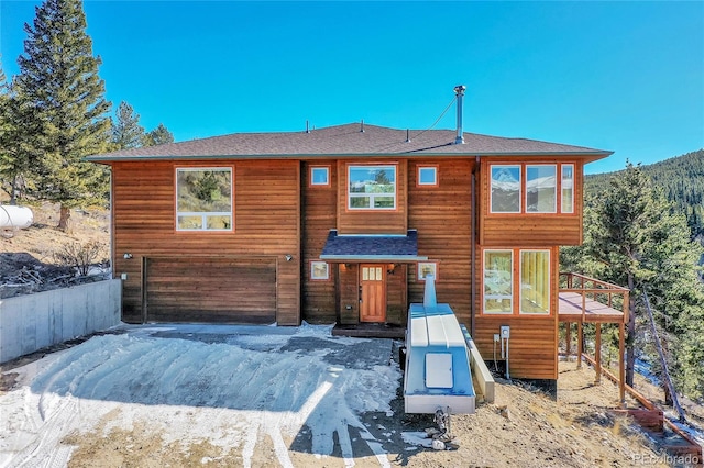 54 Doe Trl, Nederland, CO 80466 - chalet / cabin featuring a garage, a shingled roof, and a wooden deck