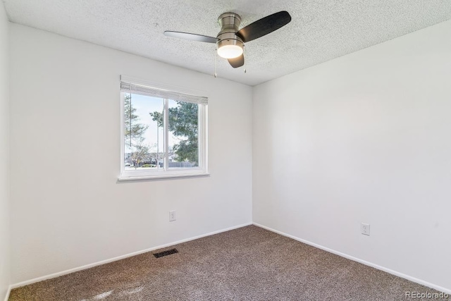 empty room featuring baseboards, a ceiling fan, carpet flooring, and a textured ceiling