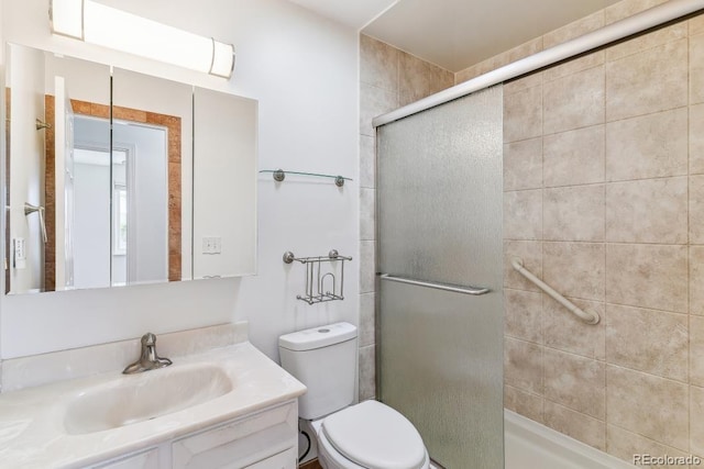 full bath featuring vanity, a shower stall, and toilet