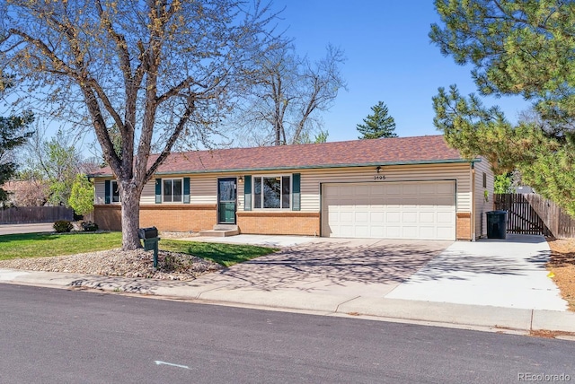 ranch-style home with a garage, fence, concrete driveway, and brick siding