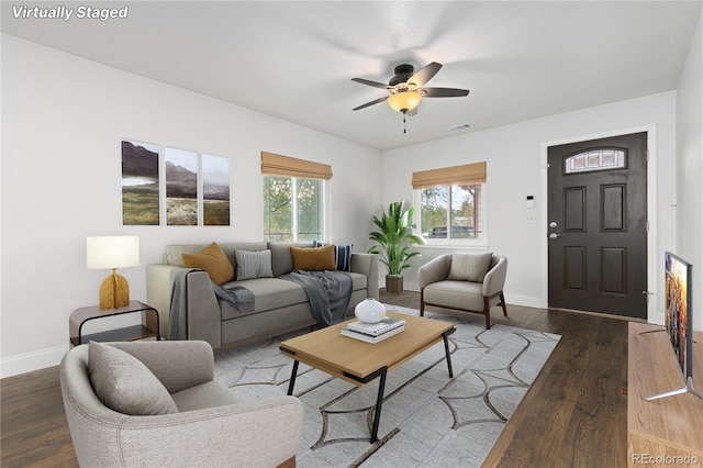 living room featuring ceiling fan and dark hardwood / wood-style flooring