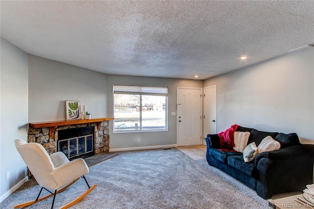 living room featuring carpet, a fireplace, baseboards, and a textured ceiling