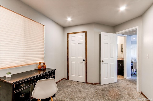 office space featuring light carpet and baseboards