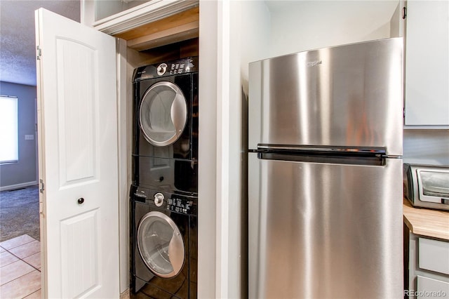 laundry room featuring stacked washer and dryer and laundry area