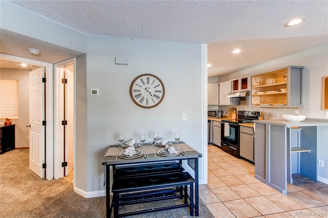 kitchen featuring open shelves, light countertops, stainless steel microwave, electric range, and under cabinet range hood